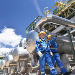 Two Oilfield Workers Inspecting Oil Refinery